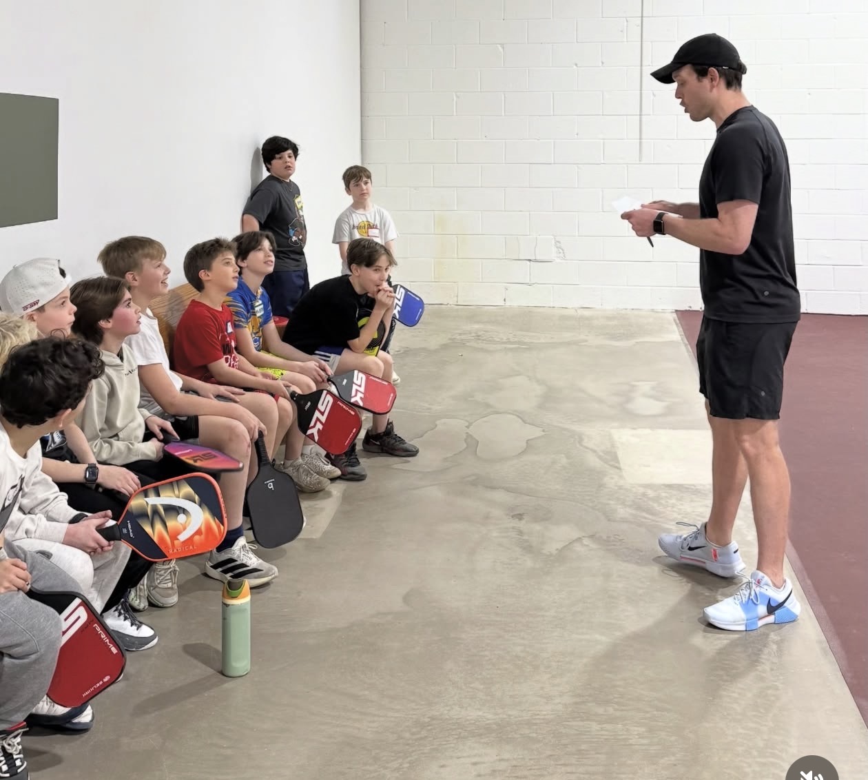 Joey Manchurek briefing a group of young players before a session